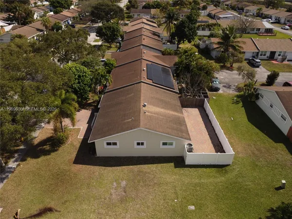 an aerial view of a house with a yard