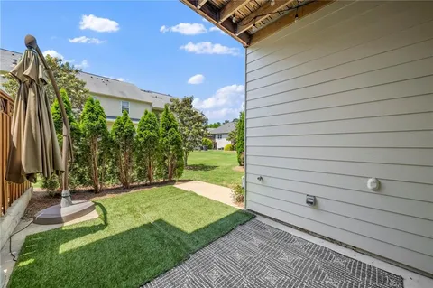 a view of a backyard with plants and brick walls
