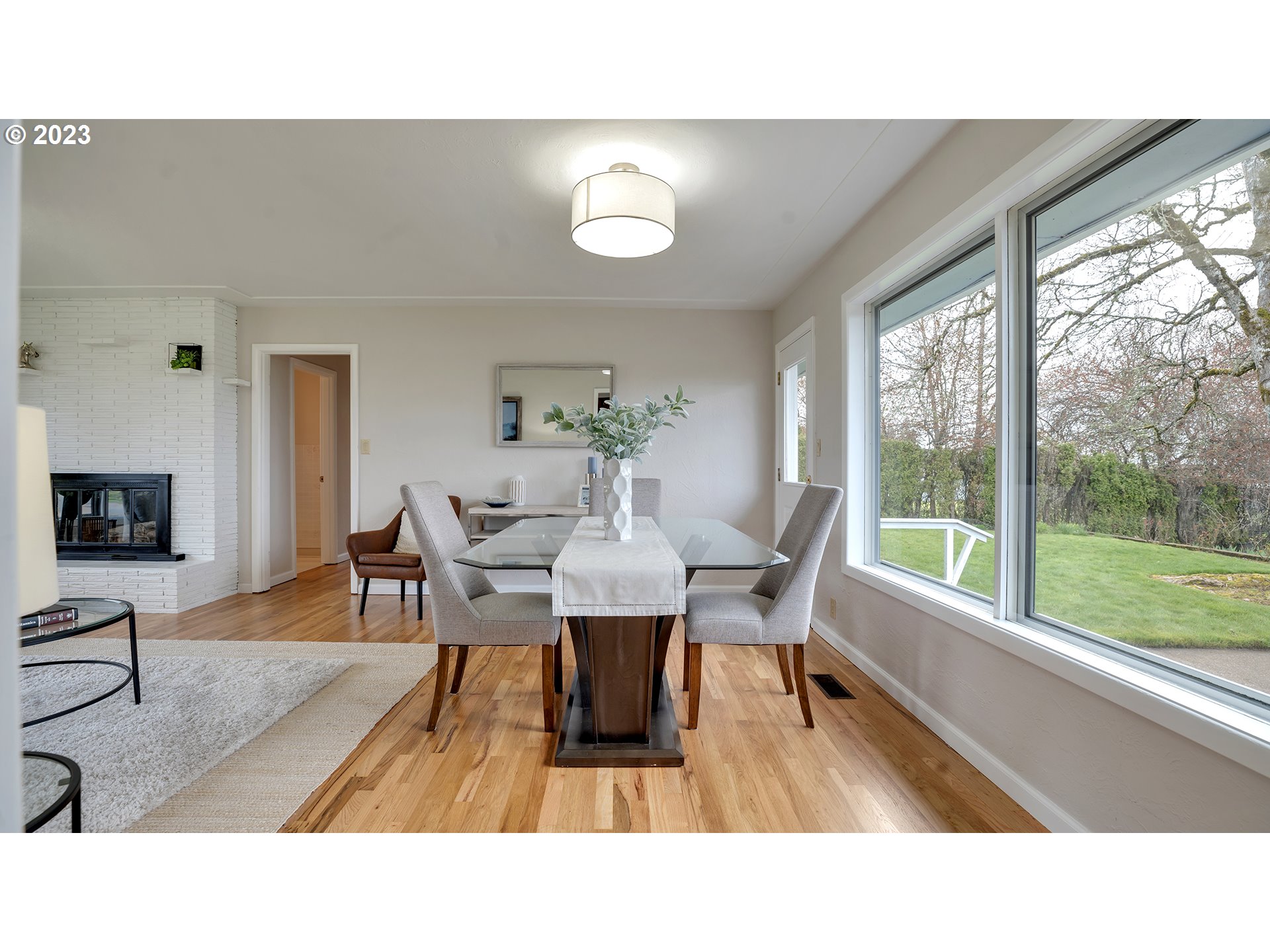 163 Northwest Reed Lane Dallas, OR 97338 - Photo 8 of 30 a living room with furniture a wooden floor and a large window