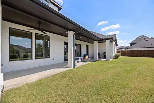a swimming pool with an outdoor seating and yard