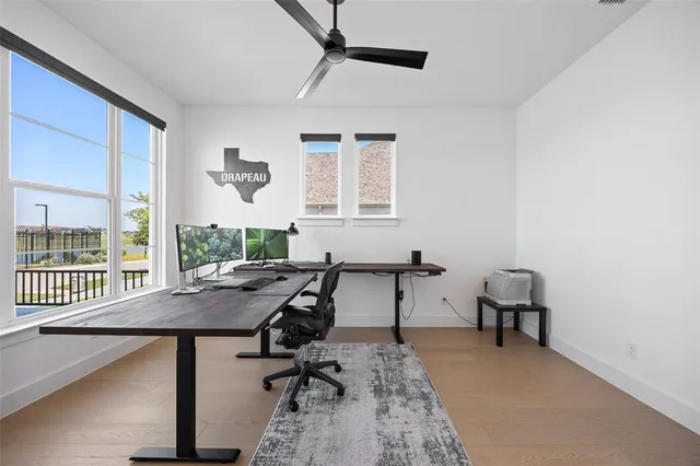 a view of a workspace with furniture and a window