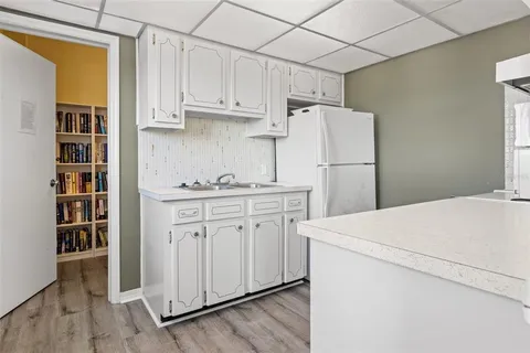 a view of a patio with a table and chairs with wooden fence