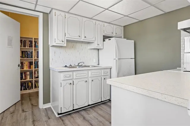 a view of a patio with a table and chairs with wooden fence