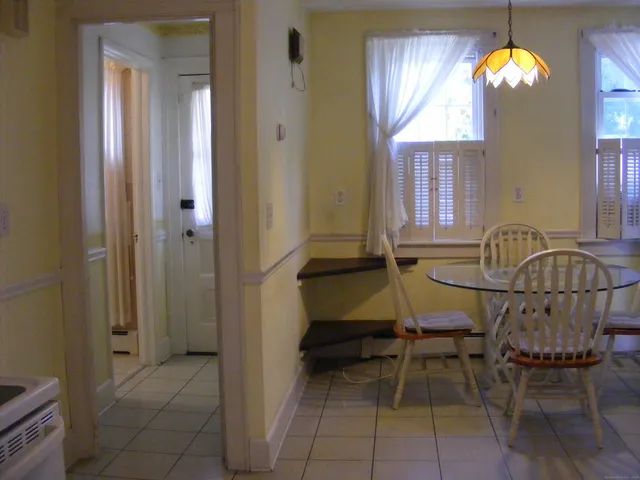 a view of a dining room with furniture and window