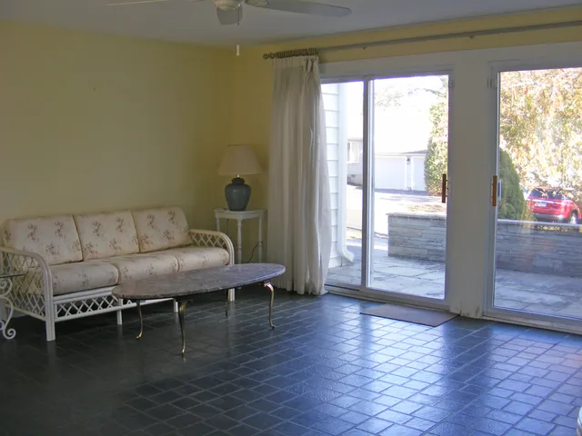 a bedroom with a balcony a bed and a window