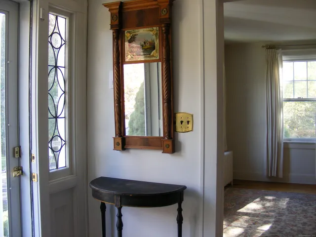 a view of entryway and hall with a door