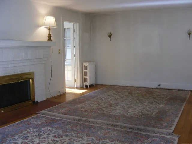 a view of empty room with window and fireplace