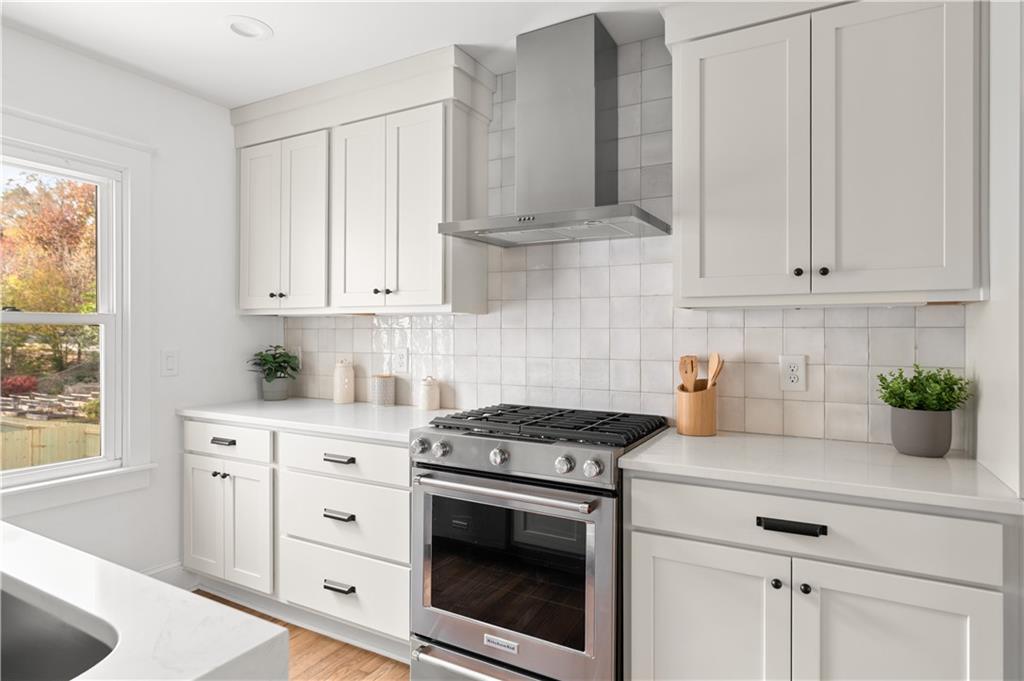 845 Ormewood Terrace Southeast, Unit A Atlanta, GA 30316 - Photo 12 of 34 a kitchen with granite countertop white cabinets and white appliances