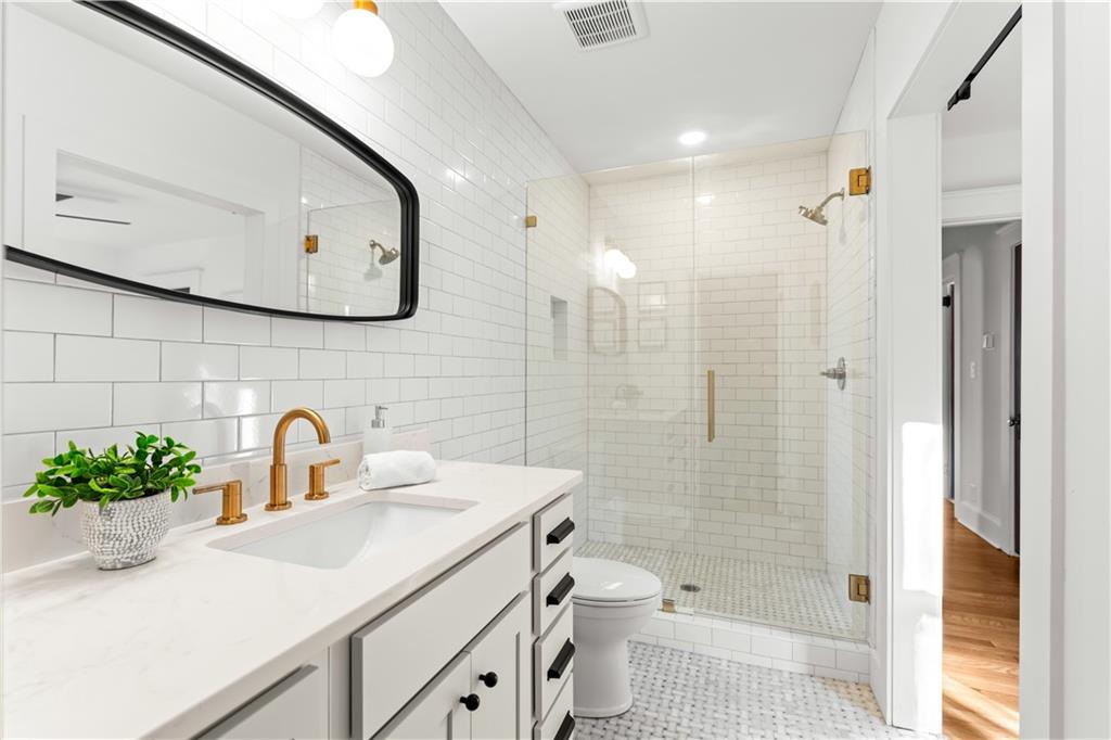 845 Ormewood Terrace Southeast, Unit A Atlanta, GA 30316 - Photo 14 of 34 a bathroom with a sink a toilet and shower