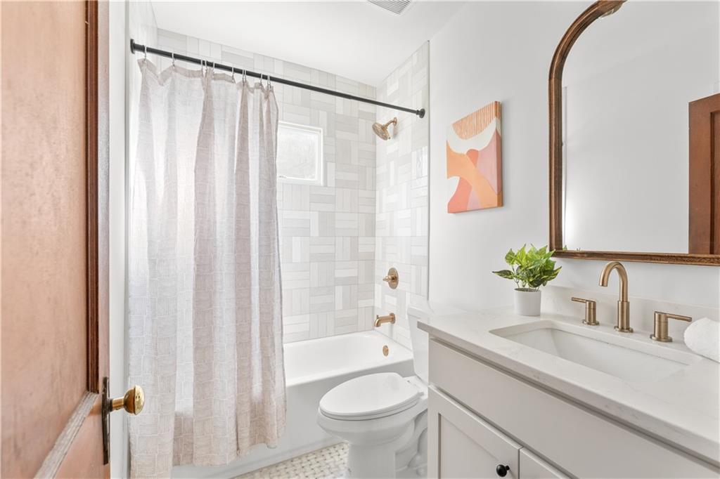845 Ormewood Terrace Southeast, Unit A Atlanta, GA 30316 - Photo 16 of 34 a bathroom with a sink a toilet and a mirror