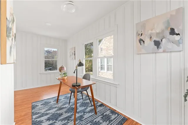 a living room with furniture and a wooden floor