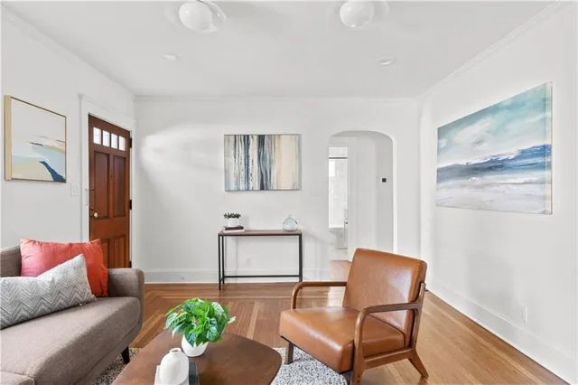 a kitchen that has a lot of cabinets in it and wooden floors