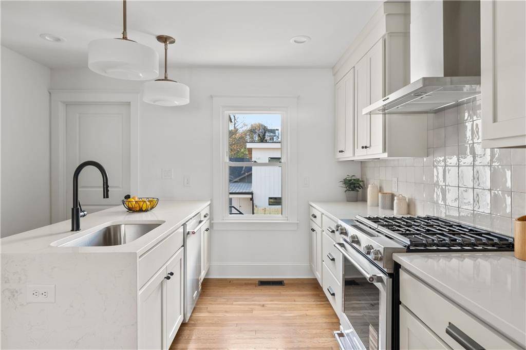 845 Ormewood Terrace Southeast, Unit A Atlanta, GA 30316 - Photo 22 of 34 a kitchen that has a lot of cabinets in it and wooden floors