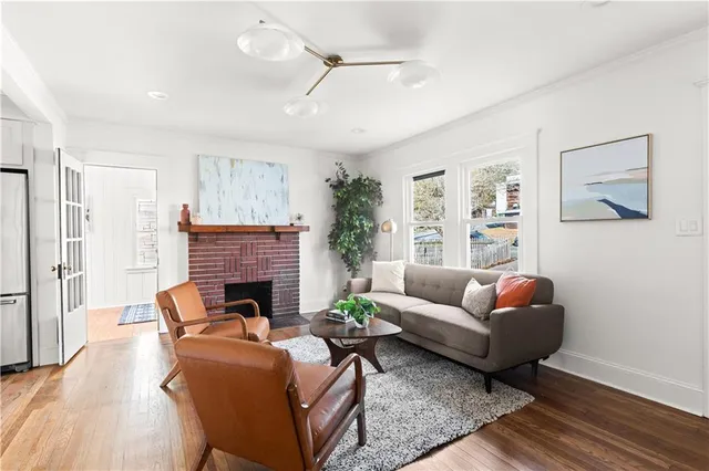 a living room with furniture a fireplace and a flat screen tv