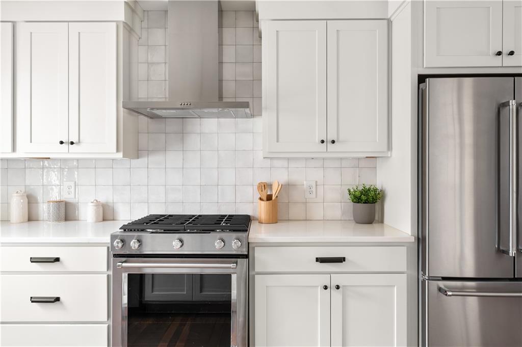 845 Ormewood Terrace Southeast, Unit A Atlanta, GA 30316 - Photo 4 of 34 a kitchen with stainless steel appliances white cabinets and a stove top oven