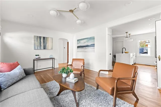 a kitchen with stainless steel appliances granite countertop a white stove top oven with white cabinets