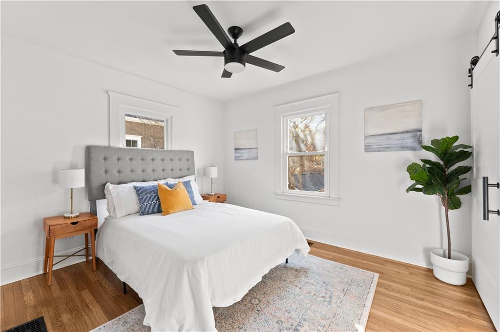 845 Ormewood Terrace Southeast, Unit A Atlanta, GA 30316 - Photo 9 of 34 a bedroom with a bed a dresser and wooden floor