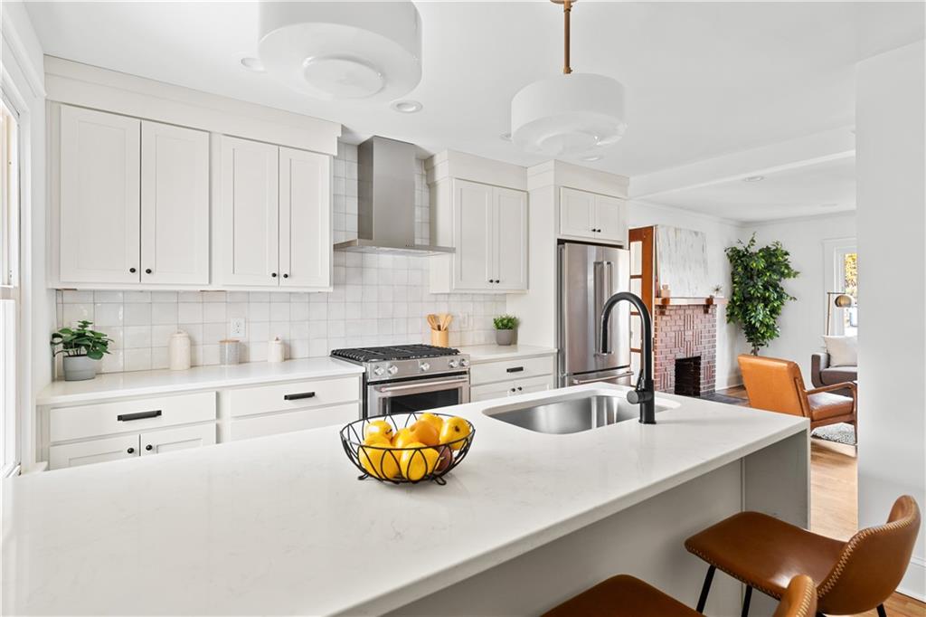 845 Ormewood Terrace Southeast, Unit A Atlanta, GA 30316 - Photo 10 of 34 a kitchen with a sink a stove and chairs