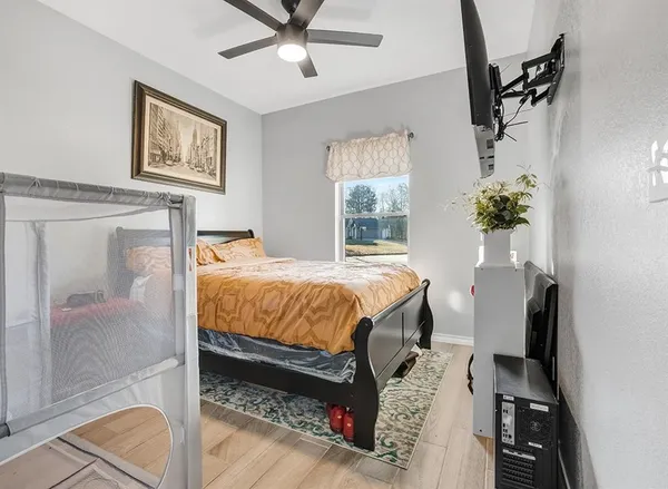 a bed sitting in a bedroom next to a window