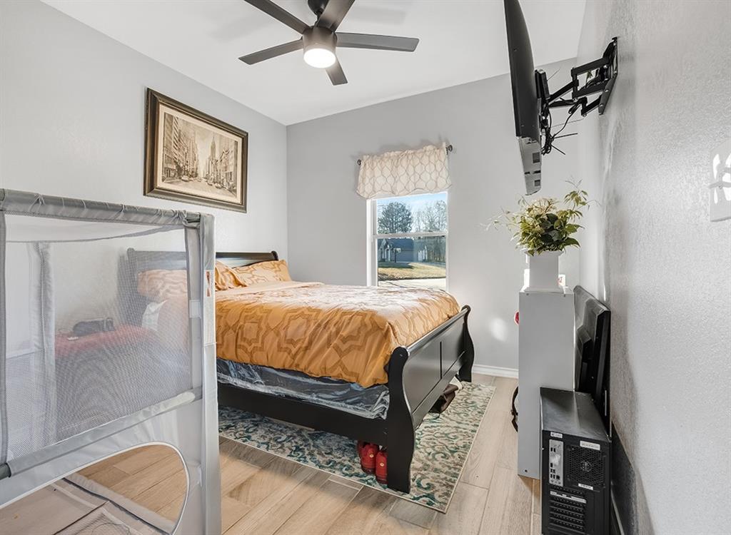 523 Mitchell Ryan Wake Village, TX 75501 - Photo 12 of 37 a bed sitting in a bedroom next to a window