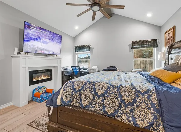 a bedroom with a bed and a fireplace