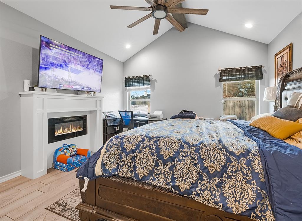 523 Mitchell Ryan Wake Village, TX 75501 - Photo 23 of 37 a bedroom with a bed and a fireplace