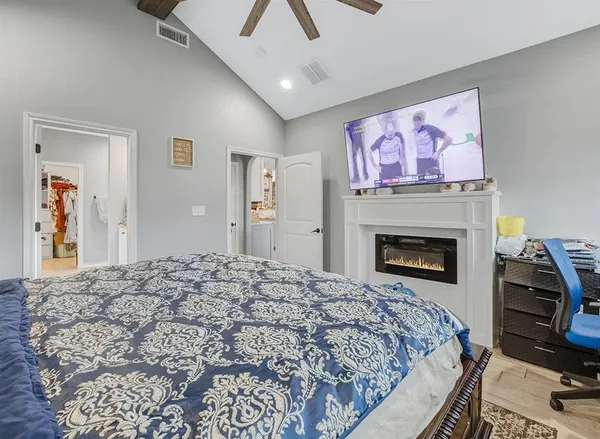 a bedroom with a bed and a fireplace