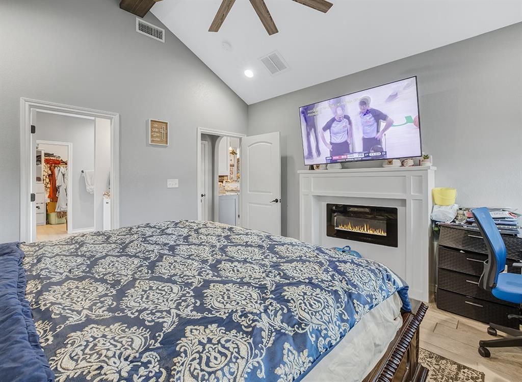523 Mitchell Ryan Wake Village, TX 75501 - Photo 27 of 37 a bedroom with a bed and a fireplace