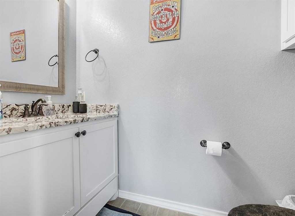 523 Mitchell Ryan Wake Village, TX 75501 - Photo 28 of 37 a bathroom with a sink and a mirror