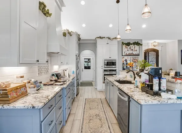 a large kitchen with granite countertop a lot of counter space