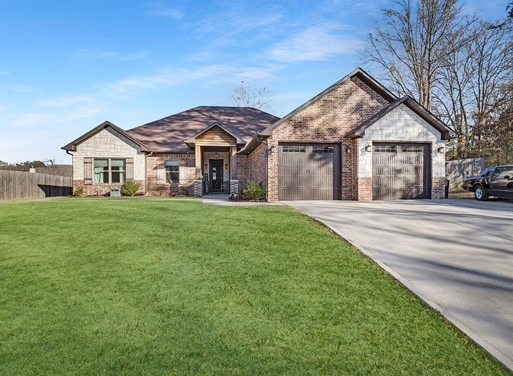 523 Mitchell Ryan Wake Village, TX 75501 - Photo 5 of 37 a front view of a house with a yard