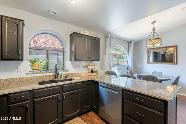 a kitchen with a sink cabinets and window