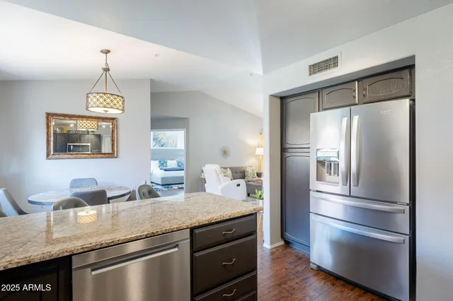 a kitchen with a refrigerator and a sink