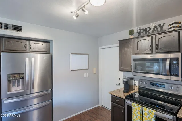 a kitchen with a refrigerator stove and microwave
