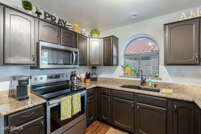 a kitchen with a sink stove and microwave