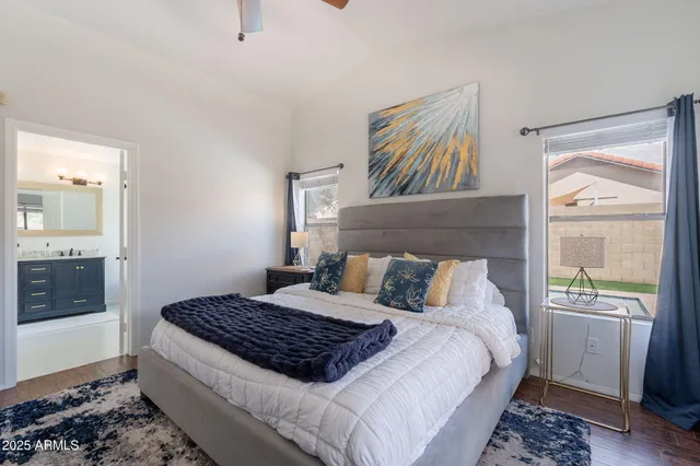 a bedroom with a large bed and a window