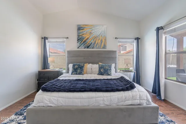 a bedroom with a large bed and a window