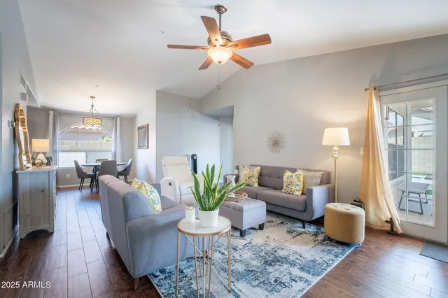 a living room with furniture and wooden floor
