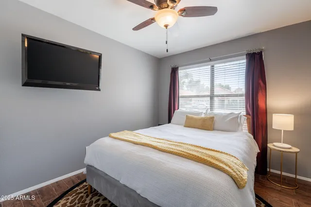 a bedroom with a bed and a flat screen tv