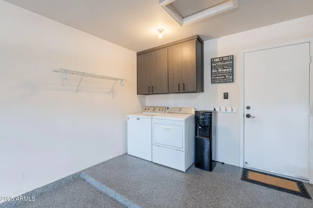 a view of a storage & utility room with closet dryer