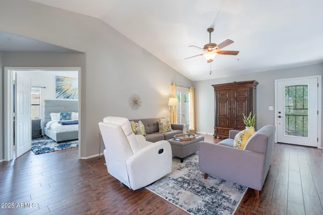 a living room with furniture and wooden floor