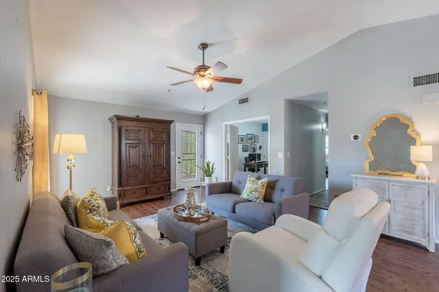 a living room with furniture and wooden floor