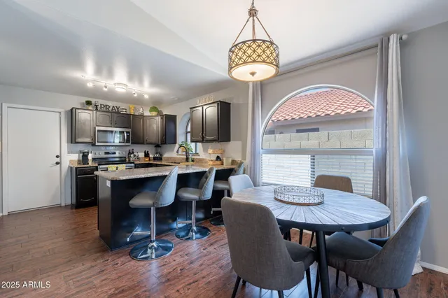 a view of a dining room with furniture wooden floor and chandelier