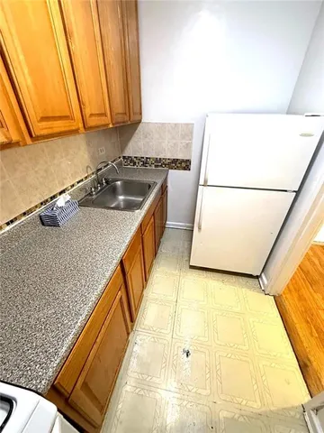 a kitchen with a sink a stove and a microwave