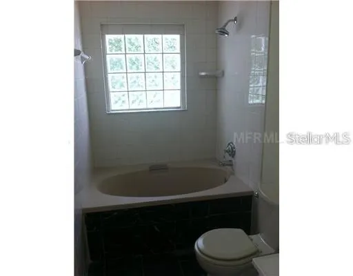 a bathroom with a toilet and a window
