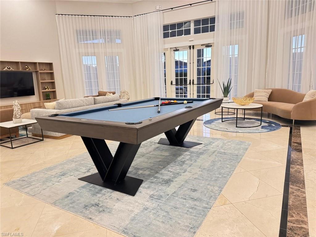 Undisclosed Address Naples, FL 34119 - Photo 13 of 20 a living room with a couch and a flat screen tv