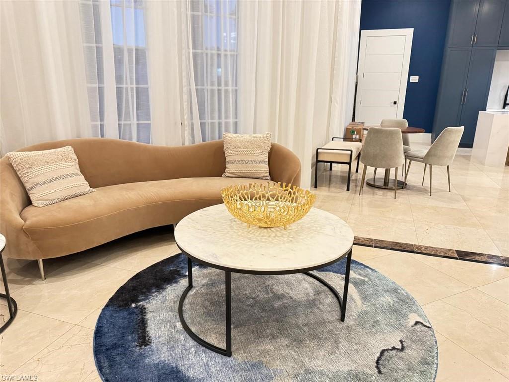 Undisclosed Address Naples, FL 34119 - Photo 16 of 20 a living room with furniture and a table