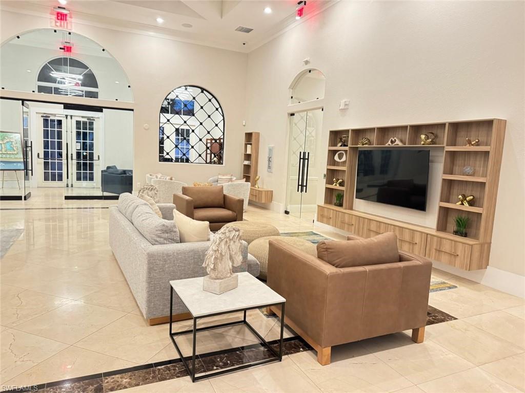 Undisclosed Address Naples, FL 34119 - Photo 17 of 20 a living room with furniture a flat screen tv and a chandelier