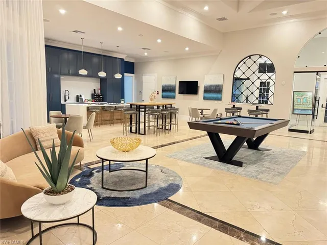 a living room with fireplace furniture and a view of kitchen