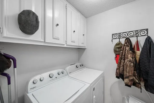 a view of walk in closet with clothes